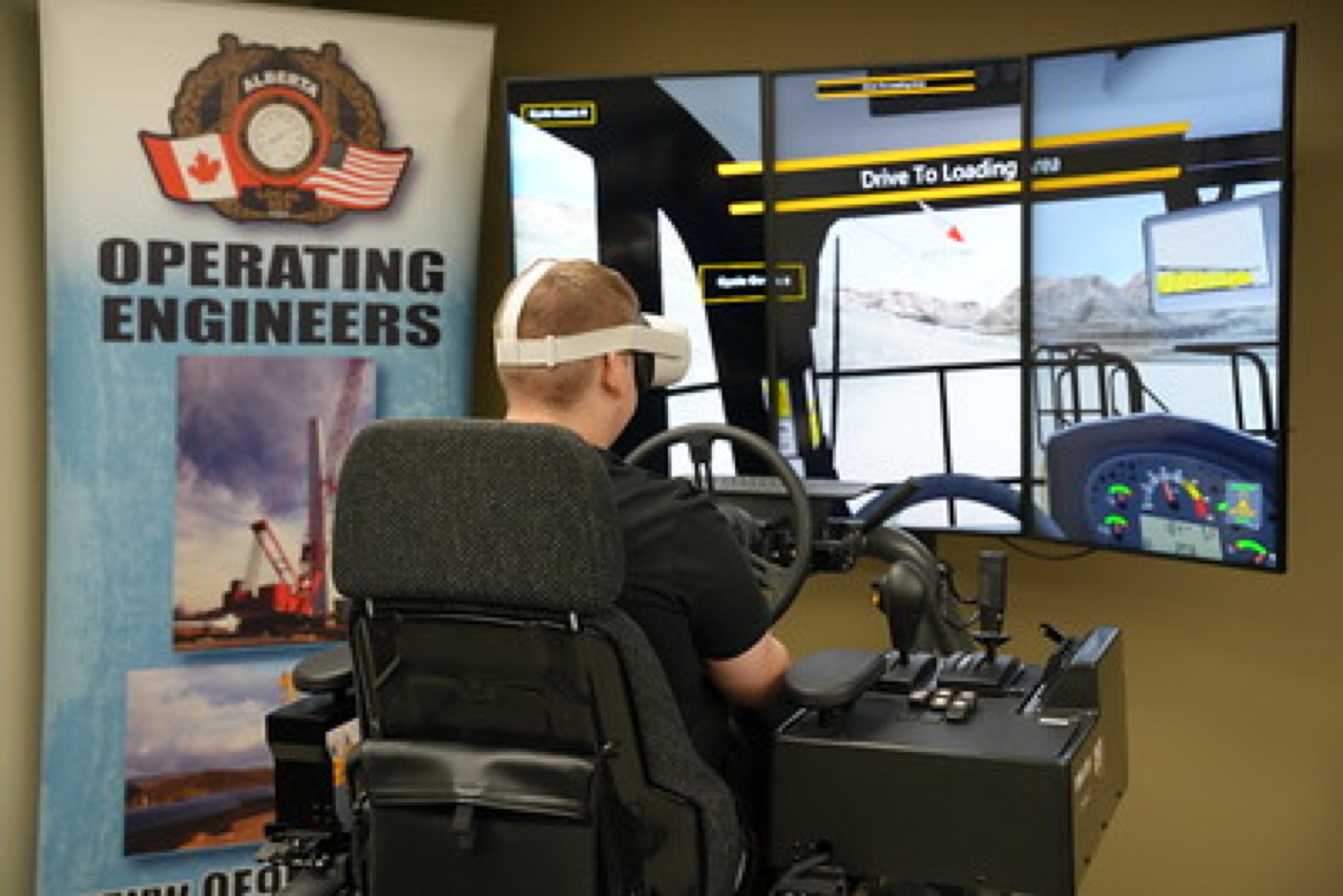 Trainee using a VR heavy-equipment operator simulator at the Operating Engineers training centre