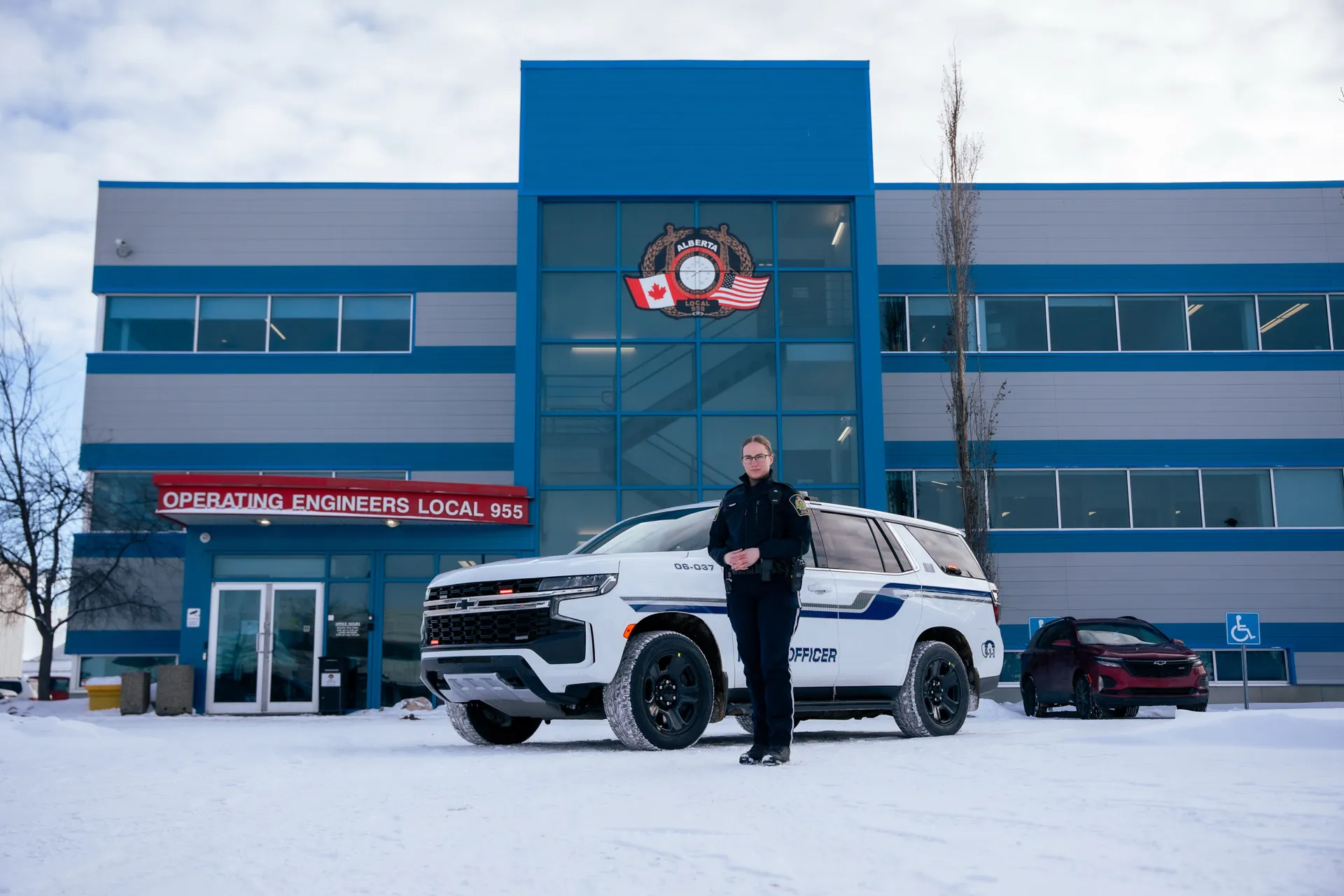 Peace officer and patrol SUV outside the Operating Engineers Local 955 headquarters in winter